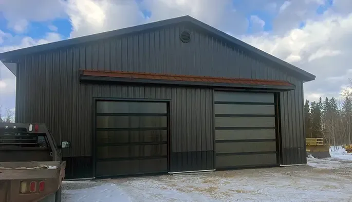 A large detached garage with two wide full-glass garage doors